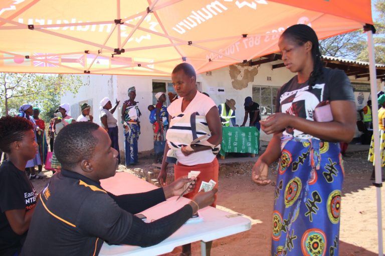 Lady receiving her cash entitlement in ward 8 Kariba